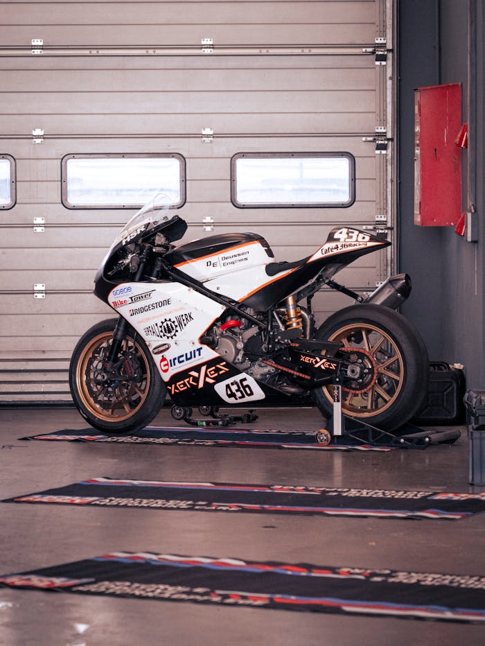 A high-performance racing motorcycle parked inside a Nürburg garage, showcasing sleek design and speed.