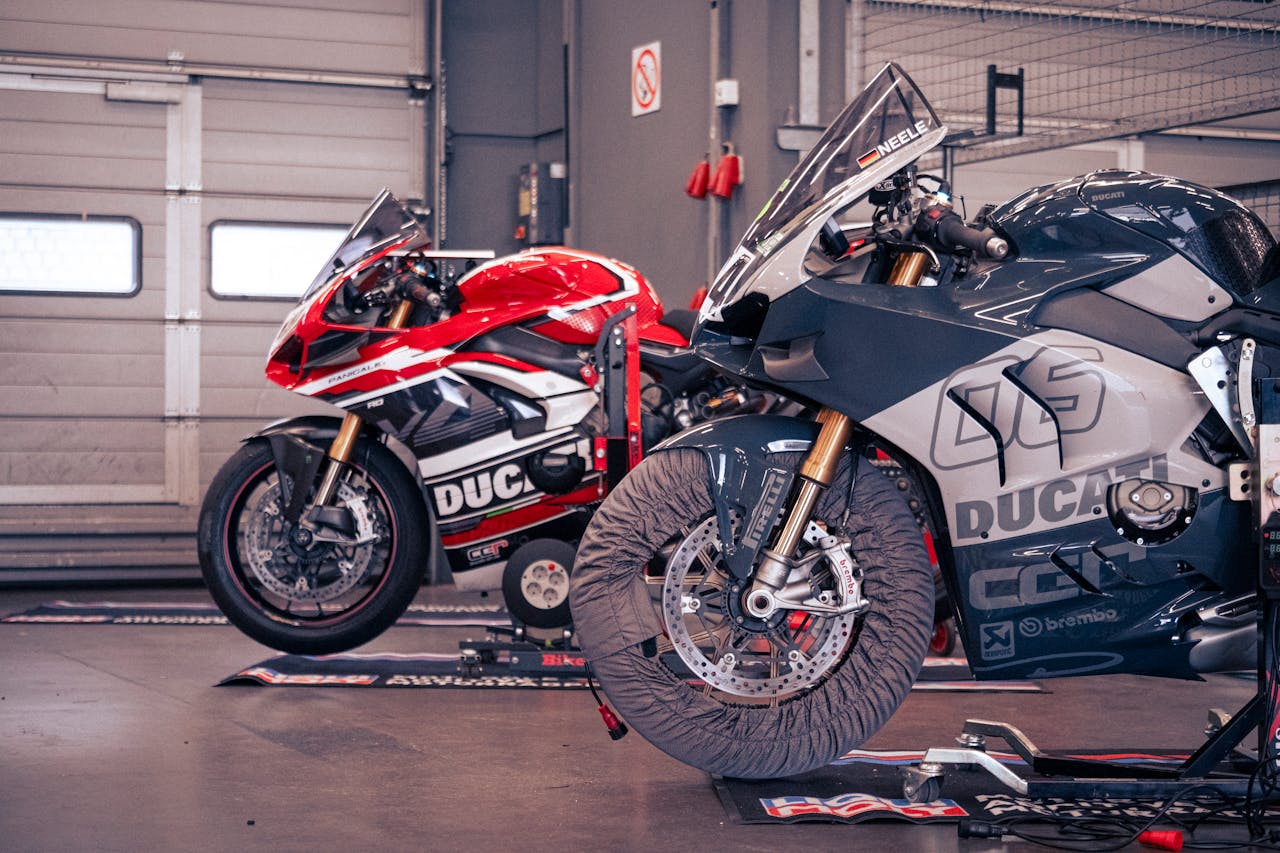 Two Ducati motorcycles in a garage at Nürburgring, perfect for racing enthusiasts.